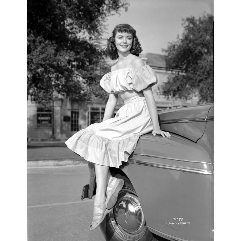 Dorothy-Malone-on-a-Ruffled-Dress-sitting-on-a-Vintage-Car-Photo-Print.jpg