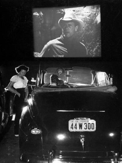 -taking-order-from-couple-in-convertible-car-during-movie-at-rancho-drive-in-theater_u-l-p448f40.jpg